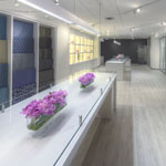 This 2,900 square foot showroom for a wallcovering and fabric supplier is designed to highlight their wide range of textures and materials.  A subtle color scheme created by white-washed plank flooring and white laminate millwork allows for the full expression of the continuously changing product lines.  Not only can the removable panel wallcoverings be updated seasonally, but the custom sliding track system was designed to create spatial flexibility as well.  An endless combination of panel layouts gives the showroom the ability to arrange comparisons for a particular client or built-in cabinets millwork details were also designed to provide future flexibility while providing the much needed storage for their vast catalog of textiles.  